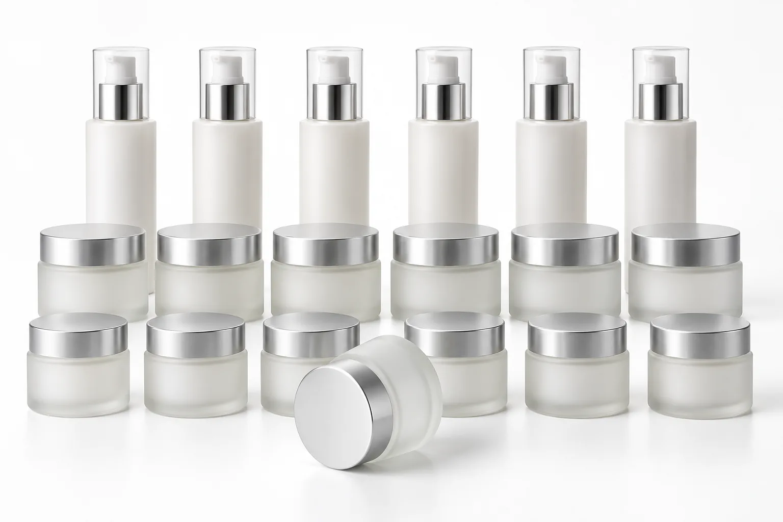 Illustrative rows of unlabelled bottles and jars on a white studio surface