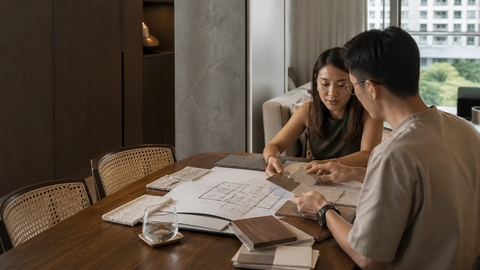 Interior consultation illustration showing a discussion of floor plans and material samples